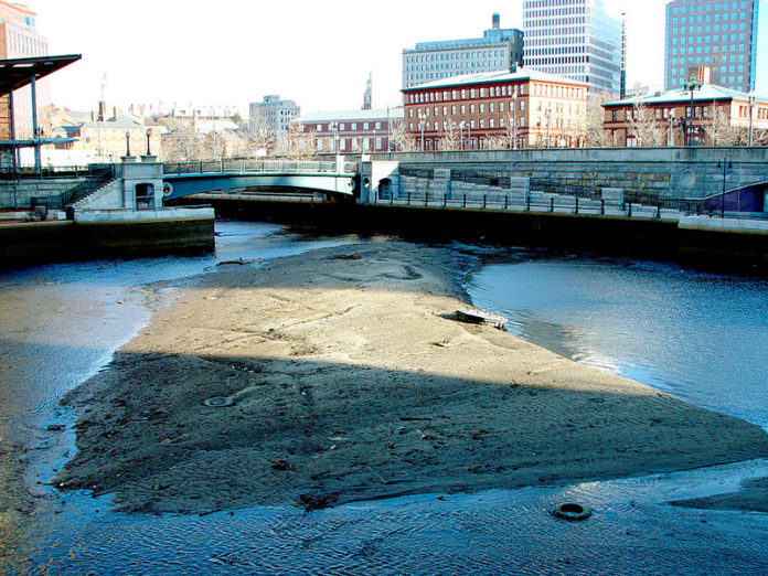 TURBULENT WATERS: A 2007 photo showing the buildup of material and low water level in a downtown waterway that can make navigation by WaterFire boats impossible. / COURTESY WATERFIRE