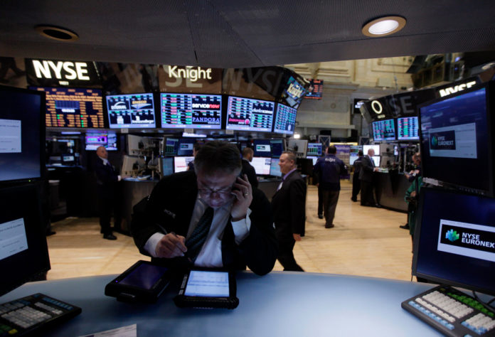 STOCKS FELL EARLY MONDAY, despite good news on U.S. retail spending in April, in contrast to last week, which saw the domestic stock market hit new highs. Here, a trader works on the floor of the New York Stock Exchange in New York on May 10. / BLOOMBERG NEWS FILE PHOTO/JIM LEE