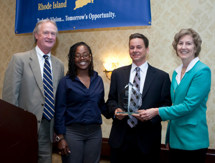 GOV. LINCOLN D. CHAFEE and Governor's Workforce Board Chair Constance Howes present Building Futures participant Tara Freeman and Building Futures Executive Director Andrew Cortes with the 2013 GWB Innovation Award at the board's annual meeting. / COURTESY THE GOVERNOR'S WORKFORCE BOARD/JOE GIBLIN
