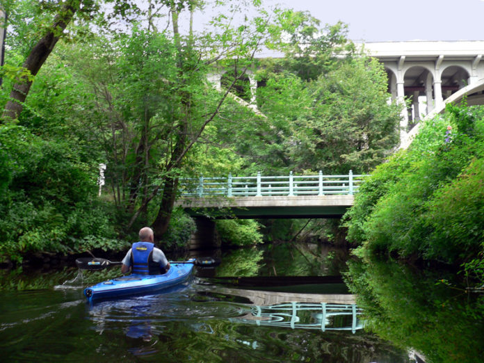 RIVER RUNS THROUGH IT: A paddler on the Blackstone River canal in a 2011 photo. Robert Billington, president of the Blackstone Valley Tourism Council, is looking to create a greater connection among southern New England tourism assets. / COURTESY CHERYL THOMPSON