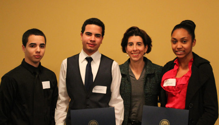 RHODE ISLAND GENERAL TREASURER GINA M. RAIMONDO recently presented the Treasury Young Leader Award to 37 students. Pictured from left to right are student John Carlos Utate and Alejandro Claudio, with Raimondo and student Jailene Rodriguez.