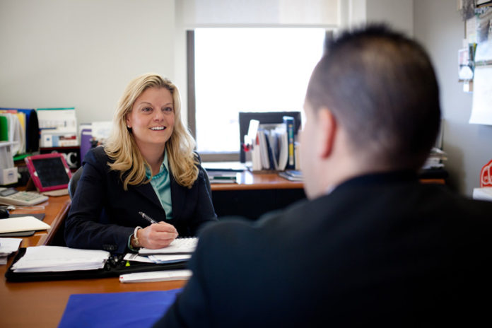 DOING IT ALL: When Bank Rhode Island converted its investment services to an internal division, Melissa Trapp – shown above speaking with colleague Dana Sherman – took on the task, and she has been growing business and attracting talent ever since. / PBN PHOTO/STEPHANIE ALVAREZ EWENS