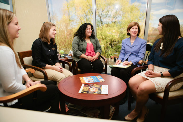 EVERYDAY MENTORING: Kati C. Machtley, second from right, meets with Bryant students who helped her put together the Women’s Summit, from left, Renee Lawlor, Kelsey Nowak, Gabriella Badaracco and McCall Peltier. / PBN PHOTO/RUPERT WHITELEY