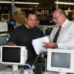 RECYCLED GOODS: Bob Gaw, right, president of Physicians Resource Network, speaks with Steven Hipolito, a sales and logistics employee at the company. According to Gaw, the company&rsquo;s warehouse has enough equipment to outfit six hospitals. / PBN PHOTO/KATE WHITNEY LUCY