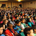 IN TUNE: Local elementary school children play along with the R.I. Philharmonic during one of six 2013 Education Concerts held during April. More than 10,000 students took part in the concert series. / COURTESY R.I. PHILHARMONIC/ RAY LARSON