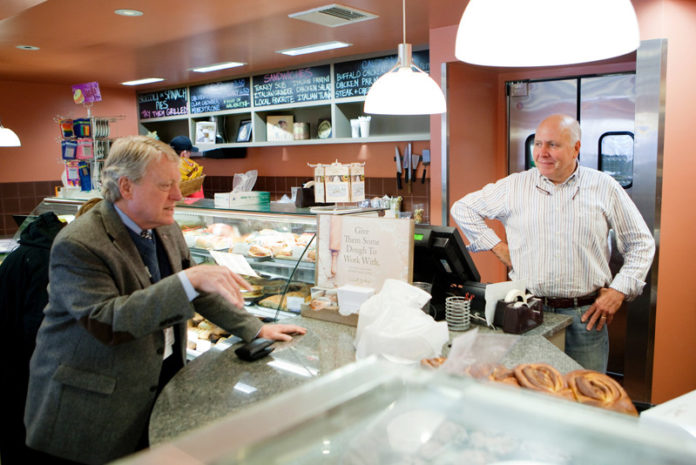 EATING CLEAN: LaSalle Bakery owner Michael Manni, right, speaks with a customer. He says his two-location company  employs 12 certified food-safety managers, more than it ever had in the past. / PBN PHOTO/RUPERT WHITELEY