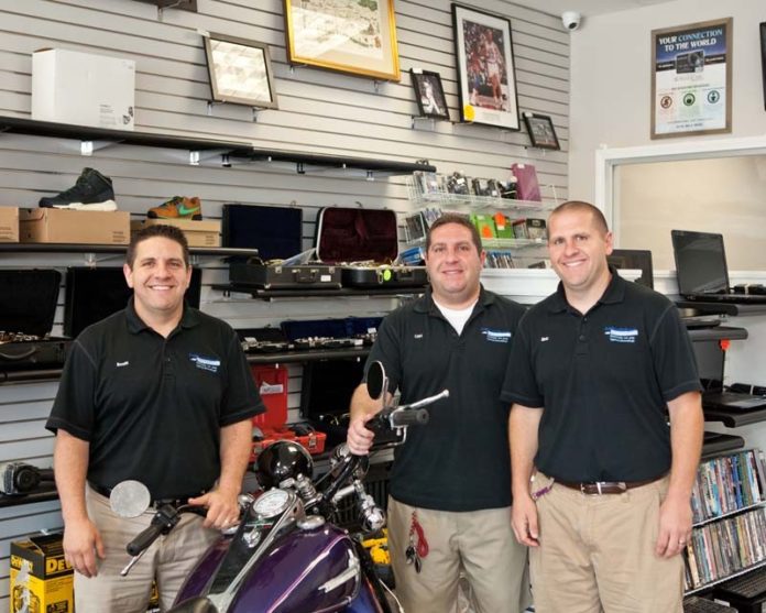 SETTING UP SHOP: From left: Brothers Scott, Cliff and Eric Frye founded Fastcash Pawn & Checkcashers in 2003. Since then, they’ve looked to grow their business among higher-end clientele. / PBN PHOTO/TRACY JENKINS