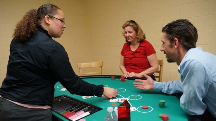 BET ON IT: Twin River Casino employee Alicia Chattman deals to Lyn Dupree and Brian LeBeau, during training for this week’s introduction of table games. / COURTESY TWIN RIVER