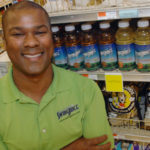 This energy drink swings for fences JUICED UP: Jon Mason shows off a display of Swing Juice in Providence’s East Side Marketplace, the product of his seven-year-old effort inspired by a golf outing with a friend. / PBN PHOTO/BRIAN MCDONALD