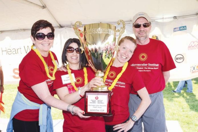 THE MIRIAM HOSPITAL employees, from left, Karen Joost, Jaime Longval and Monica Anderson accept the fundraising award from Miriam President Arthur J. Sampson at the Southern New England Heart Walk in May at Colt State Park in Bristol. / COURTESY LIFESPAN
