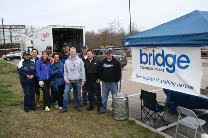 BRIDGING GAPS: Bridge employees volunteer for the company&rsquo;s e-Waste Drives, held twice a year in the spring and fall, to promote proper recycling of hazardous electronic waste. In the April 2013 drive, volunteers collected almost 4.5 tons of e-waste. / COURTESY BRIDGE TECHNICAL TALENT