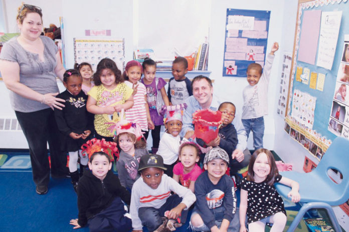 A SERVICE TO FRIENDS: Keith Leduc, senior audit manager, center-right, was one of several KLR employees who participated in the Children&rsquo;s Friend and Service&rsquo;s collaborative reading program in Providence. / COURTESY KLR