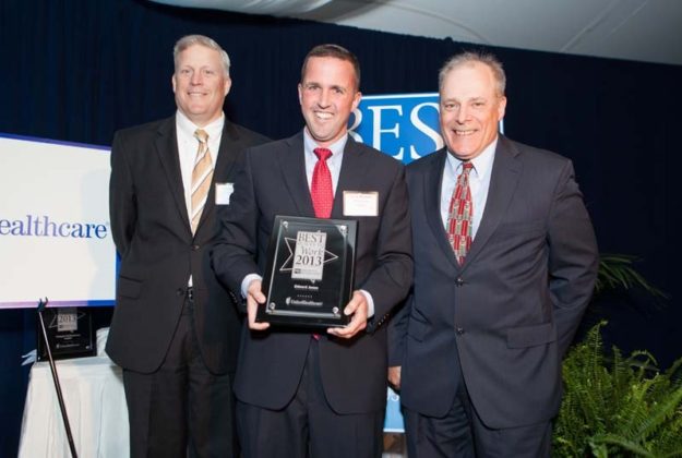 Kevin Hylander, Edward Jones, accepts his award from Stephen Farrell, UHC and Mark Murphy, PBN / Rupert Whiteley