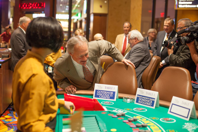 GOV. LINCOLN D. CHAFEE surveys the blackjack table on Wednesday as he, and other attendees, prepared to play in a blackjack tournament celebrating the opening of table games at Twin River. / COURTESY TWIN RIVER CASINO