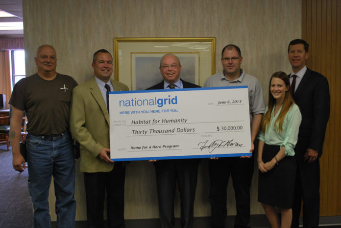 FROM LEFT: Richard DeFazio, telecom technician, National Grid; John Kennedy, distributed-generation consultant, National Grid; Lou Raymond, executive director, South County Habitat for Humanity; Sean McGovern, collection’s agent, National Grid; Sarah Duphilly, development and marketing manager, South County Habitat for Humanity; Timothy Horan, president, National Grid, Rhode Island.