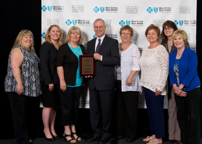 WOOD RIVER HEALTH SERVICES President and CEO Michael A. Lichtenstein and members of the health center staff receive the Outstanding Achievement Award. With Lichtenstein, center, are from left: Linda Conway, Wood River Health; Kim Cormier, BCBSRI director of consumer-activation strategic marketing and product innovation; Dianne Langlais, human resources director, Wood River Health; Peg Marcotte, administrative assistant, Wood River Health Services; Donna Murtha, dental hygienist; Liane Girardin, financial access to care coordinator, Wood River Health; and Janet Raymond, senior vice president at the Greater Providence Chamber of Commerce.