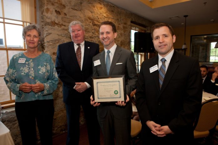 ROBERT BRUNELLE, owner of Main Street Formals, accepts the 2013 small business of the year award from members of the New Bedford Area Chamber of Commerce and BankFive. / COURTESY NEW BEDFORD AREA CHAMBER OF COMMERCE/DEBORAH L. HYNES