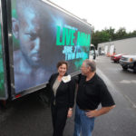 KEEPING IT MOVING: Brian and Jeanne Evans, owners of mobile-outdoor marketing company Promotion With Motion, show off their mobile screen. Building more trucks is the firm&rsquo;s next move, they say. / PBN PHOTO/BRIAN MCDONALD