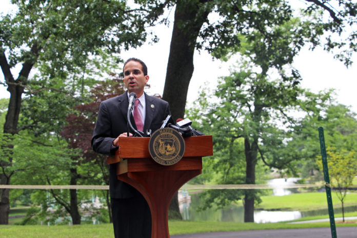 Providence Mayor Angel Taveras on July 2 announces completion of more than $400,000 in stormwater improvements to Roger Williams Park to restore water quality in 100 acres of historic ponds. The work included creation of five major stormwater-treatment areas, removal of paved surfaces and the addition of a new walking path. Volunteers planted more than 3,000 native wetland plants to reduce water pollution and restore eroded shorelines. The city also completed a water-quality restoration plan for the ponds. / COURTESY PROVIDENCE MAYOR’S OFFICE