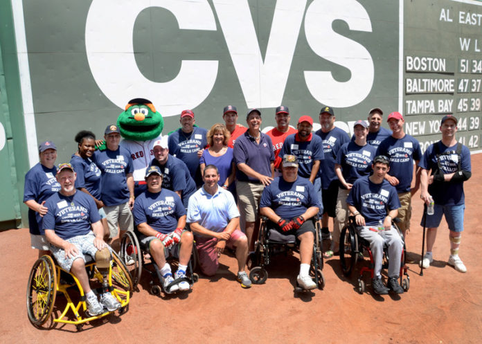 Disabled military veterans from across New England participate in a CVS Caremark Baseball Camp on July 3 at Fenway Park. The camp is a partnership between CVS Caremark and the Boston Red Sox. Veterans worked with Red Sox Hitting Coach Greg Colbrunn and Assistant Hitting Coach Victor Rodriguez. They took swings at the Green Monster and enjoying lunch in the dugout, a tour of the park and tickets to that evening’s game against the San Diego Padres. / COURTESY CONSTANCE BROWN
