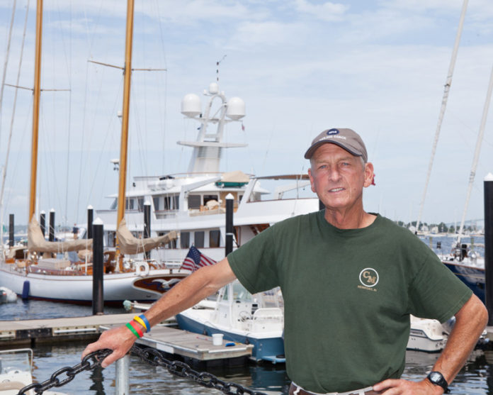Bill Casey, pictured above at Newport’s Casey’s Marina, runs a host of marine-related businesses. There’s Casey’s, the signature business, which he started in 1986 at an old fish dock. He also operates two other Newport marinas, hauls and repairs boats, has a fresh fish and lobster store and leases space to several marine-related companies. Casey docks mega-yachts from around the world at the three marinas. And he runs a fuel business. So, how does he do it all? “You just keep putting one foot in front of the other and make it happen,” he said. / PBN PHOTO/TRACY JENKINS