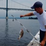 RWU’s Taylor reels in grant for scup research SOMETHING IN THE WATER: Roger Williams University associate professor of biology David Taylor catches scup north of Dyer Island in Narragansett Bay for research on mercury levels in the popular fish. / COURTESY RWU