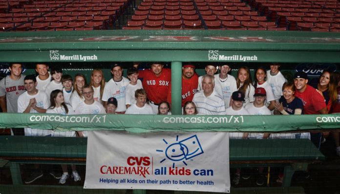 THE GLOCESTER LITTLE LEAGUE CHALLENGER TEAM, a baseball team devoted to children with physical and/or developmental disabilities, in the Boston Red Sox dugout with Hitting Coach Greg Colbrunn, Assistant Hitting Coach Victor Rodriguez and CVS Caremark District Manager Mike Goduto. / COURTESY CONSTANCE BROWN