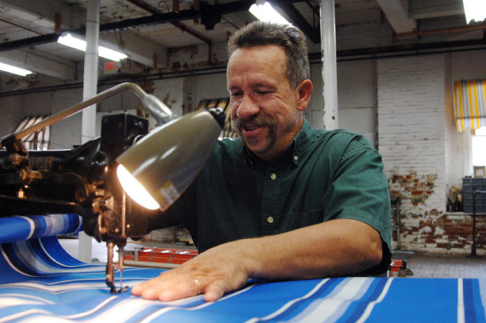 REDUCING OVERHEAD: Dave Dansereau operates his Woonsocket Awning Co. under the mantra of “all awnings are custom-made by owner on premises.” A focus on energy efficiency, as well as a sluggish economy, have helped his business. / PBN PHOTO/BRIAN MCDONALD