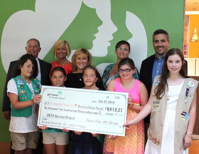 LOCAL GIRL SCOUTS present a check to Heart and Hope Fund, front row, from left, girl scouts: Alissa Robtaille, Genevieve Cava, Ila-ann Smith, Danica Aguiar, and Cassidy DeMayo; back row, from left: Ron Cascione, Heart & Hope Fund board member, Louise Dinsmore, executive director, Heart & Hope Fund, Ginger Lallo, director of product sales, GSRI, Nancy Aguiar, and Christopher Plante, Heart & Hope Fund board members.
