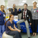 TAKING ADVANTAGE: The multi-faceted wellness program at Visiting Nurse Home Care brings the staff health benefits as well as a more connected workplace. Showing off different aspects of the fitness options are, from left, Chelsea Vincente, Maureen Flanagan, Phil Laboeuf, Matt Coupe and Susan Bleuel. / PBN PHOTO/RUPERT WHITELEY
