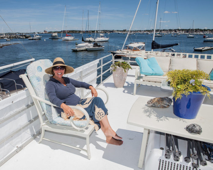 FLOAT ON: Danielle Bolender, manager at Lilypad in Newport Harbor, says the houseboat business has grown into a year-round operation. Lilypad is joined in Rhode Island waters by new arrivals to the Fox Point area in Providence. / PBN PHOTO/TRACY JENKINS