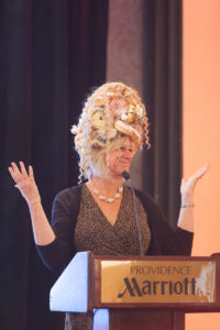 Keynote Speaker Joy Feldman, a nutritionist and author, shows the audience her "Donut Hair Hat" that she wears when visiting schools for readings of her childrens' book "Your Hair is Made of Donuts." / Rupert Whiteley