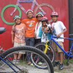 SOME OF the 60 children from around Providence participating in the Red Shed Bike Shop's first Bike Camp stand with their bikes. All participants received their own bicycle, lock, and helmet and learned how to ride, maintain, and stay safe with their bicycle.