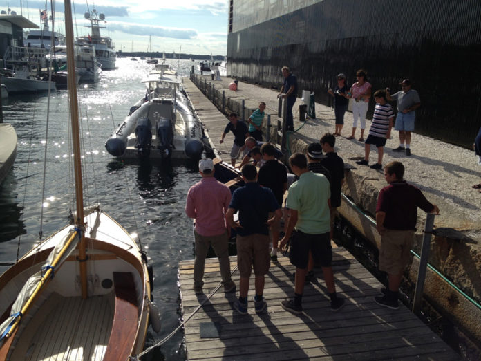 Graduates of a Tiverton High School summer boat-building program on Aug. 15 prepare to launch one of two boats they built. The six-week program was funded through the Workforce Partnership of Greater Rhode Island. The launch was held in Newport at an event hosted by the Rhode Island Marine Trades Association. / COURTESY RIMTA