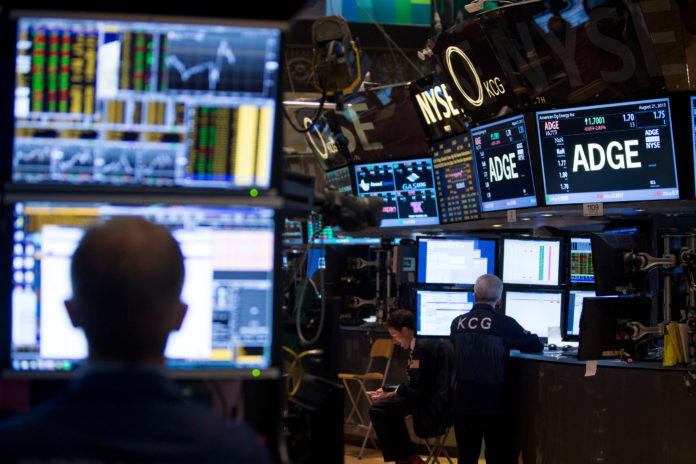 U.S. EQUITIES and bonds gained in value, as negative economic data led analysts to speculate that the Federal Reserve was going to postpone the reduction of its monetary stimulus program. Pictured is the New York Stock Exchange. / BLOOMBERG NEWS FILE PHOTO/SCOTT EELLS