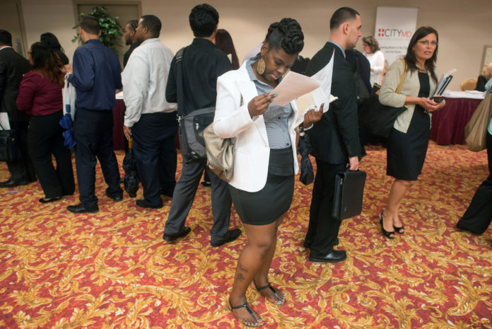 JOB SEEKERS, such as those at an Aug. 22 job fair in New York, are finding that the U.S. economy continues to improve. Second-quarter GDP growth was revised upward Thursday to 2.5 percent, following recent jobless claim numbers that hover near a five-year low. / BLOOMBERG NEWS PHOTO/CRAIG WARGA