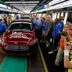Consumer spending in U.S. rises below forecast on slow wage gain IN A SIGN OF CONTINUING strong spending by American consumers, Ford is increasing the production of its midsize Fusion sedan, adding 1,400 jobs at its Flat Rock, Mich., assembly plant. The first Fusion to come off the line on Thursday is celebrated by workers and company executives. / BLOOMBERG NEWS PHOTO/JEFF KOWALSKY