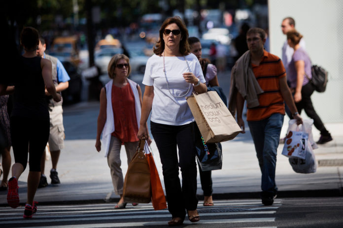 A woman carries a shopping bag on Fifth Avenue in New York. The Department of Commerce reported Friday that retail sales in the U.S. rose less than expected in August. / BLOOMBERG FILE PHOTO/VICTOR J. BLUE