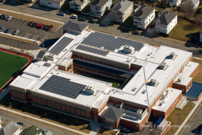BEAUMONT SOLAR completed a 61.1-kilowatt solar energy array on the roof of New Bedford's Abraham Lincoln Elementary School in December 2011, one of five municipal projects the firm has done recently and one reason it has grown in the last seven years from 11 employees to 35. / COURTESY BEAUMONT SOLAR CO.