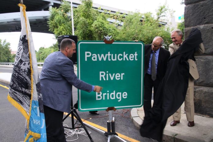 PAWTUCKET MAYOR Donald R. Grebien, from left, RIDOT Director Michael Lewis and Gov. Lincoln D. Chafee unveil the official sign for the Pawtucket River Bridge, formerly denominated as Bridge 550. / COURTESY PAWTUCKET MAYOR'S OFFICE