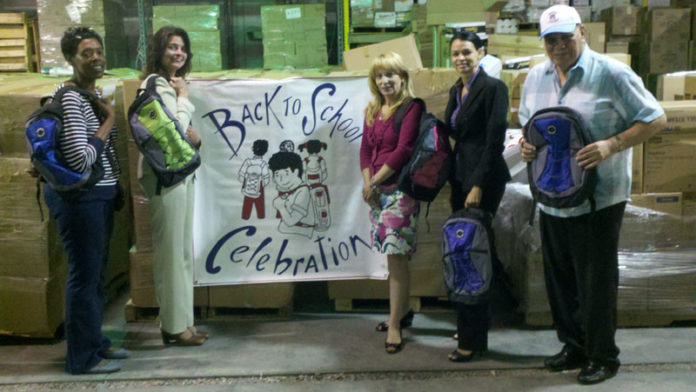 AREA AGENCIES collaborate to provide supplies for school-age children during an annual back-to-school event. From left: Jacqueline Dowdy, Neighborhood Health Plan of Rhode Island; Robin Kuznitz, office manager at Partridge Snow & Hahn LLP; Paula Manseau, United Way; Grace Gonzalez, Neighborhood Health Plan of Rhode Island; Jorge Cardenas, founder of Back to School Celebration.