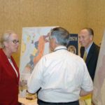 TALKING SHOP: University of Rhode Island&rsquo;s Business Engagement Center Executive Director Katharine Hazard Flynn, speaks with Portsmouth Business Development&rsquo;s William E. Clark, yellow tie, and Raymond Sepe, president and CEO of Electro Standards Laboratories, at the &ldquo;We Mean Business Expo.&rdquo; / PBN PHOTO/BRIAN MCDONALD