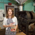 NUTS FOR IT: Candace Kaloostian, president of the Virginia & Spanish Peanut Co., represents the third generation to lead the 100-year-old company. On roasting days, the smell of hot nuts has become familiar to anyone in the blocks around the company&rsquo;s wooden factory on Dexter Street in Providence&rsquo;s West End. / PBN PHOTO/TRACY JENKINS