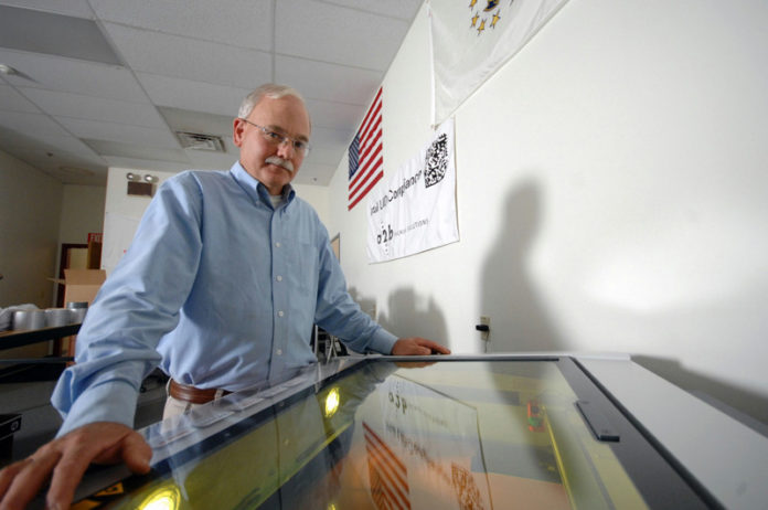 MAKING ITS MARK: A2B Tracking Solutions is a key component of a Defense Department effort to identify and track every piece of hardware it has using laser-etched bar code such as the one Glenn Hamblet is generating at the company’s Portsmouth facility. / PBN PHOTO/BRIAN MCDONALD