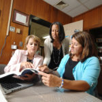 TEACH YOUR TEACHERS WELL: Christine Alves, center, director of The Teaching Studio, sees herself as “an instructional coach” for other teachers. Here she works with Giovanna Donovan, left, superintendent of the Woonsocket schools, and Donna Coderre, principal of Leo Savoie Elementary School in Woonsocket. / PBN PHOTO/BRIAN MCDONALD