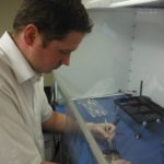 Jared Palmer, founder and owner of Data Medics LLC, works to recover data from a hard drive using a bench-top clean room.