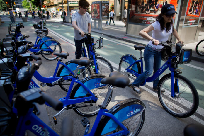 RIDERS TRY OUT the New York City bicycle sharing program in May 2013. The city of Providence this week began soliciting proposals for a similar system for neighborhoods including Downcity, College Hill and Federal Hill. / BLOOMBERG FILE PHOTO/VICTOR J. BLUE
