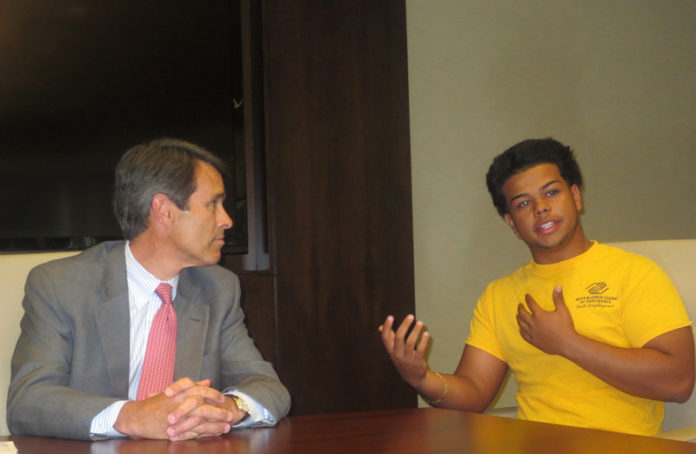 DAVID RAMOS, right, of Providence, speaks with Bank of America Rhode Island President Bill Hatfield about his first work experience at the Fox Point Clubhouse, which Ramos called “a blessing that will help shape my future.”