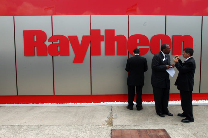 RAYTHEON RAISED its 2013 forecast for earnings and sales even as it saw a 2.8 percent decline in third-quarter profits, the company announced Thursday. / BLOOMBERG FILE PHOTO/ALASTAIR MILLER