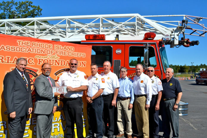 AN AERIAL LADDER TRUCK was given to the state of Rhode Island/Fleet Operations for training purposes at the R.I. Fire Academy’s new training facility in Exeter. From left: academy Director Mark Pare; R.I. Fire Marshal Jack Chartier; RIAFC board members: Tim McLaughlin; Brian Jackvony; Stuart Pearson; Brad Preston; George Farrell; Ken Finlay and Fred Stanley.
